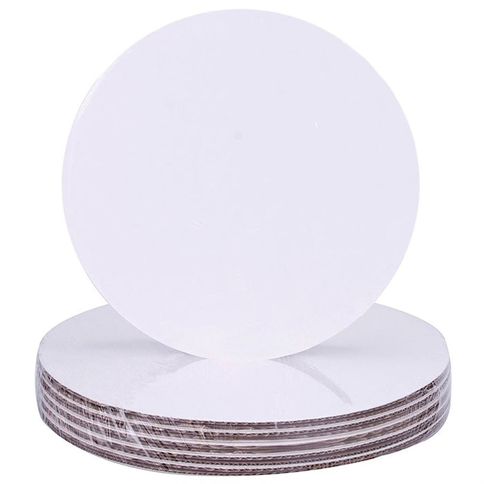 Stack of 6-inch round white greaseproof cake boards with smooth edges and kraft backing for cake display and support.