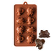 Brown silicone mold with bee, butterfly, and frog cavities for making chocolates, candies, fondant decorations, and themed treats.