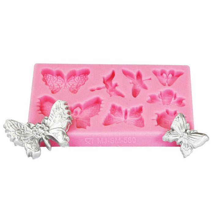 Pink butterfly and dragonfly silicone fondant mold for creating detailed cake decorations, cupcake toppers, chocolate accents, and edible dessert embellishments.