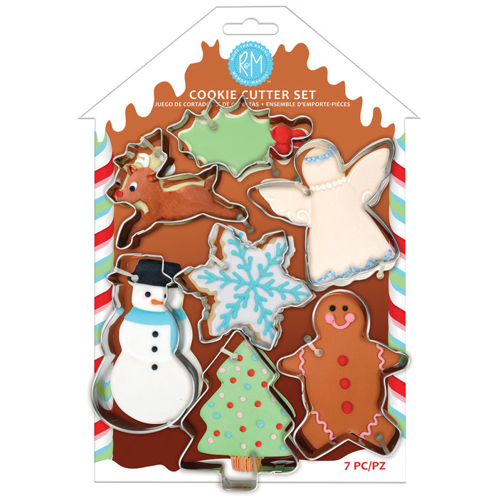 RM Cookie Cutter Set in a house-shaped packaging, containing 7 holiday-themed cookie cutters: reindeer, angel, snowman, Christmas tree, gingerbread man, and snowflake.