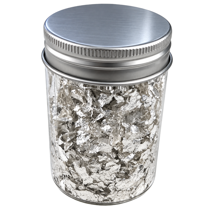 A clear cylindrical jar filled with silver metallic flakes, sealed with a brushed silver metal screw-top lid, shown on a plain white background.