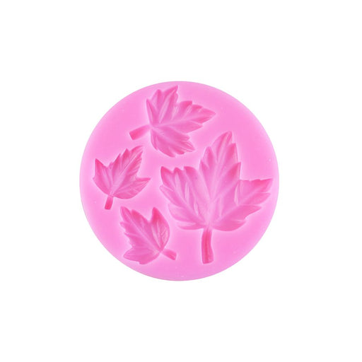 Pink 4-cavity silicone fondant mold featuring assorted detailed fall leaf designs for cakes, cupcakes, and Thanksgiving decorations.