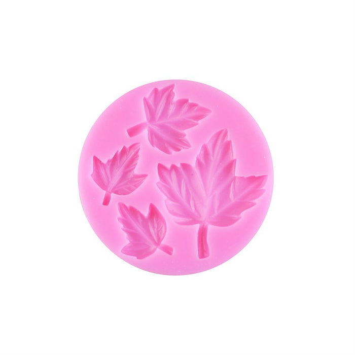 Pink 4-cavity silicone fondant mold featuring assorted detailed fall leaf designs for cakes, cupcakes, and Thanksgiving decorations.