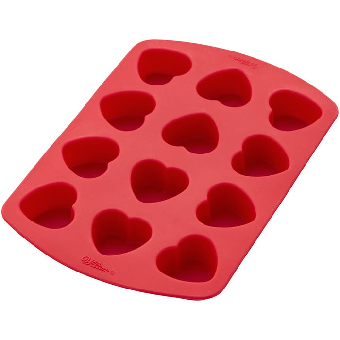 Wilton red heart silicone baking mold with 12 heart-shaped cavities for mini cakes, brownies, chocolates and Valentine's Day desserts