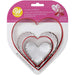 Wilton 4-piece nesting heart cookie cutter set with four graduated metal heart-shaped cutters in original pink packaging