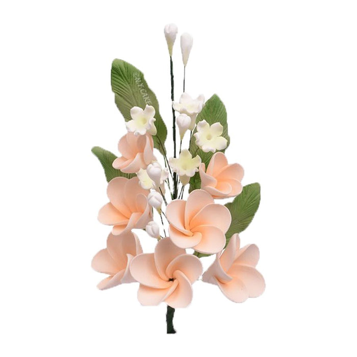 Handmade peach plumeria spray sugar flowers with green leaves for wedding cakes, tropical cakes, and elegant edible cake decorating.