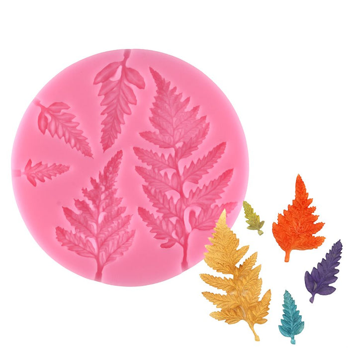 Pink silicone fondant mold with assorted detailed pine and fern leaf cavities for fondant, gum paste, chocolate and cake decorations.