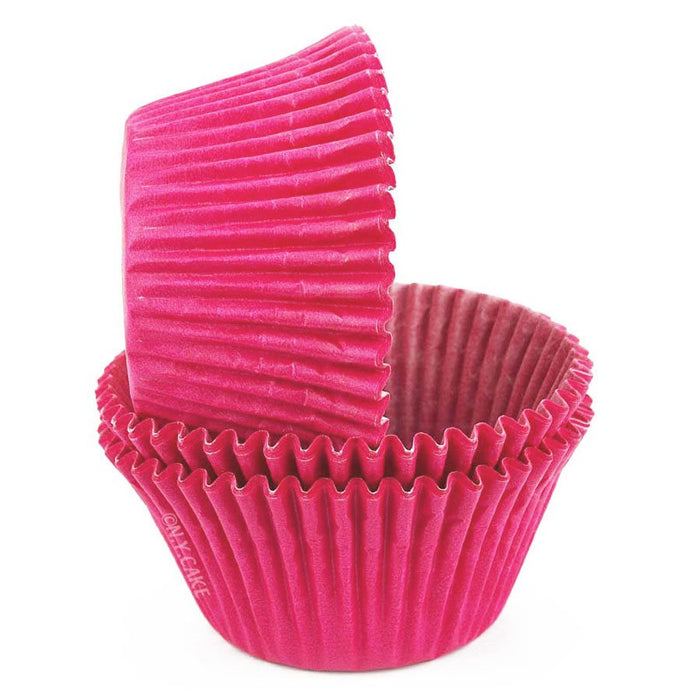 Stack of pink cupcake liners on a white background