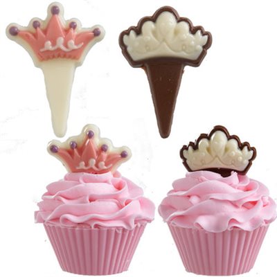 Wilton Princess Picks Candy Mold finished chocolate crown decorations in pink and white displayed on princess birthday cupcakes
