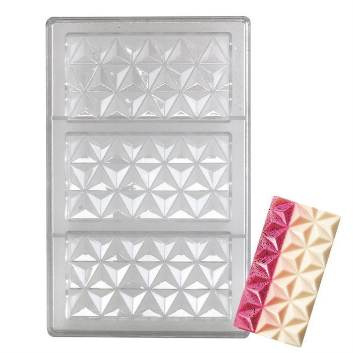 Clear polycarbonate chocolate mold with three pyramid-shaped geometric cavities displayed alongside finished chocolate bars made using the mold