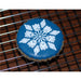 Decorated blue winter cookie with detailed snowflake stencil design