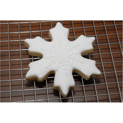 Decorated snowflake cookie made with reusable Christmas stencil