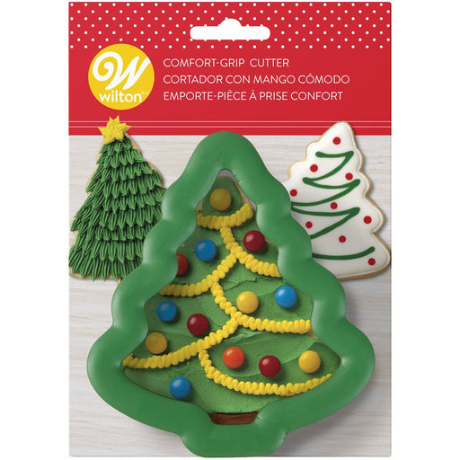 Wilton Christmas Tree Comfort Grip Cookie Cutter 3 inch in green packaging with decorated Christmas tree cookies for holiday baking