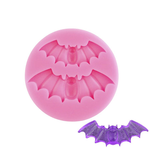 Pink silicone fondant mold with two vampire bat cavities for Halloween cake and cupcake decorations.