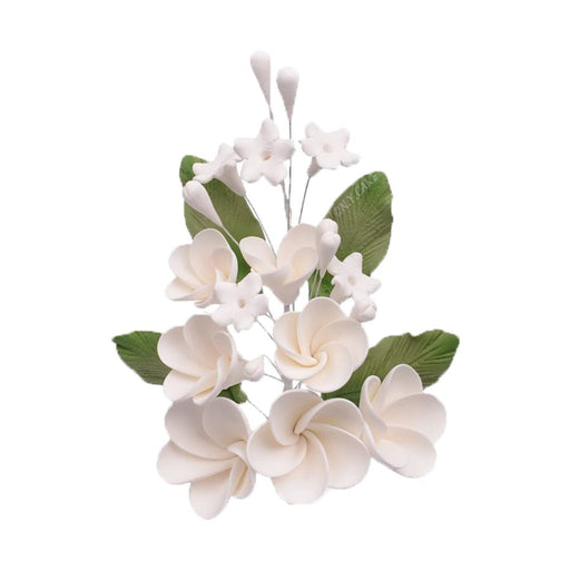 Handmade white plumeria spray sugar flowers with green leaves for wedding cakes, tropical cakes, and elegant edible cake decorating.