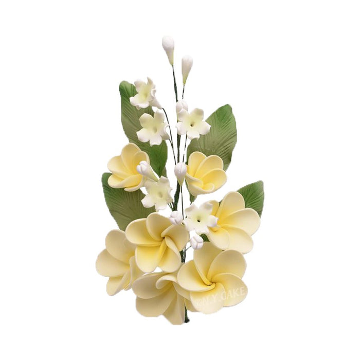 Handmade yellow plumeria spray sugar flowers with green leaves for wedding cakes, tropical cakes, and elegant edible cake decorating.